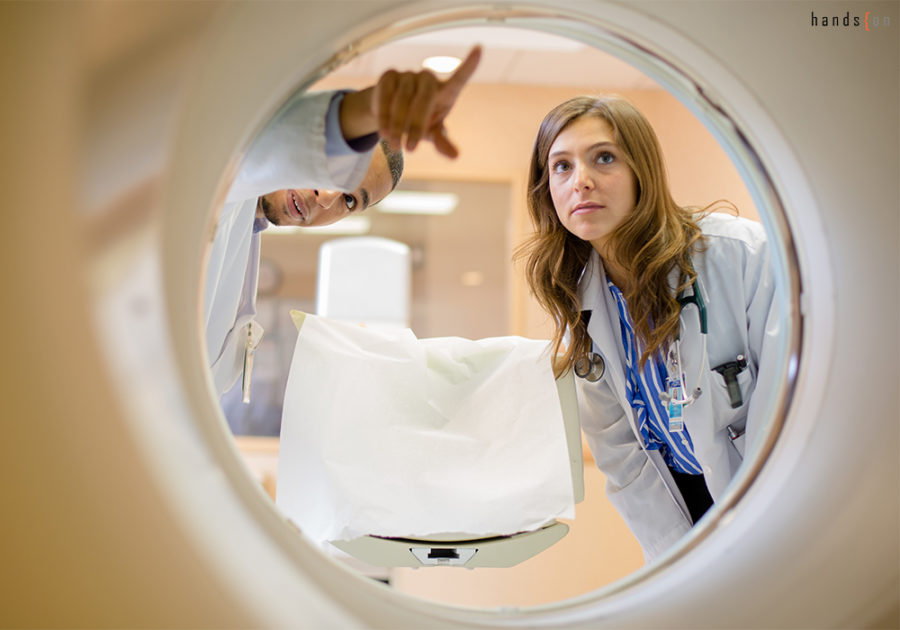 Student look into MRI machine